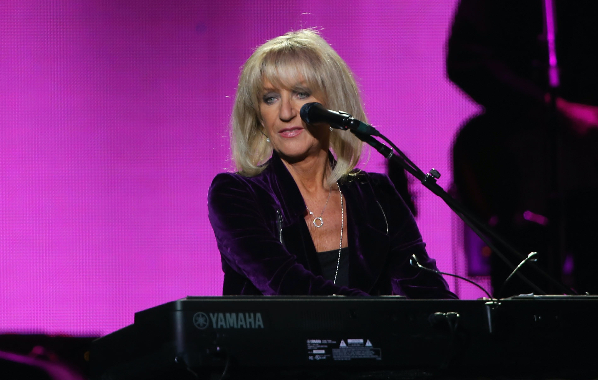 Christine McVie performing live on stage with Fleetwood Mac in 2015