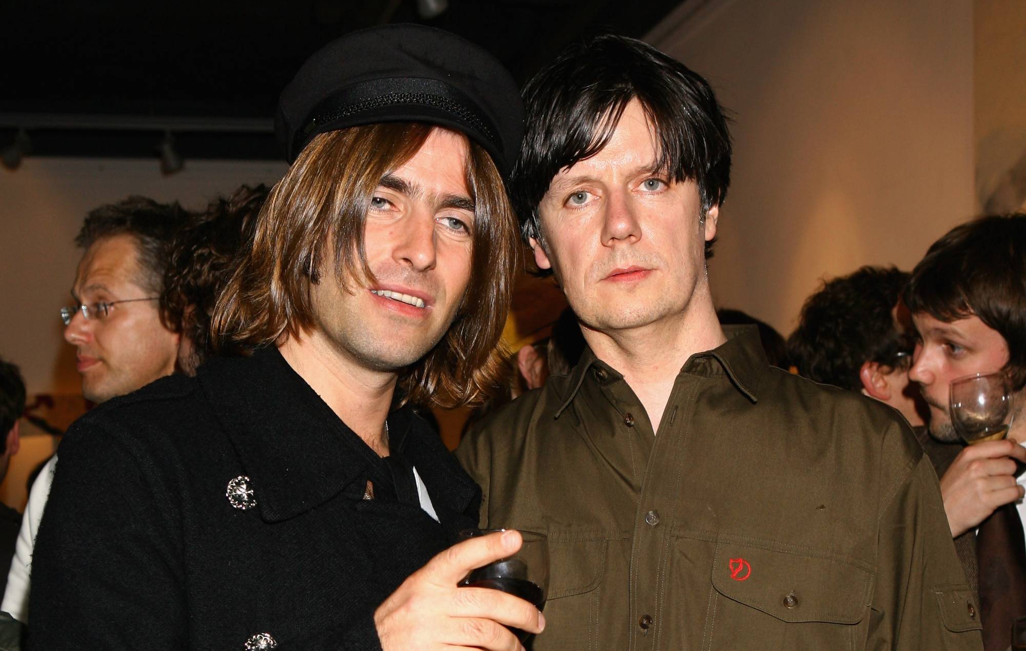 Former member of the Stone Roses turned artist, John Squire, and Liam Gallagher pose for a photograph at the New Work Exhibition at Smithfield Gallery on July 3, 2007 in London, England. (Photo by Chris Jackson/Getty Images)